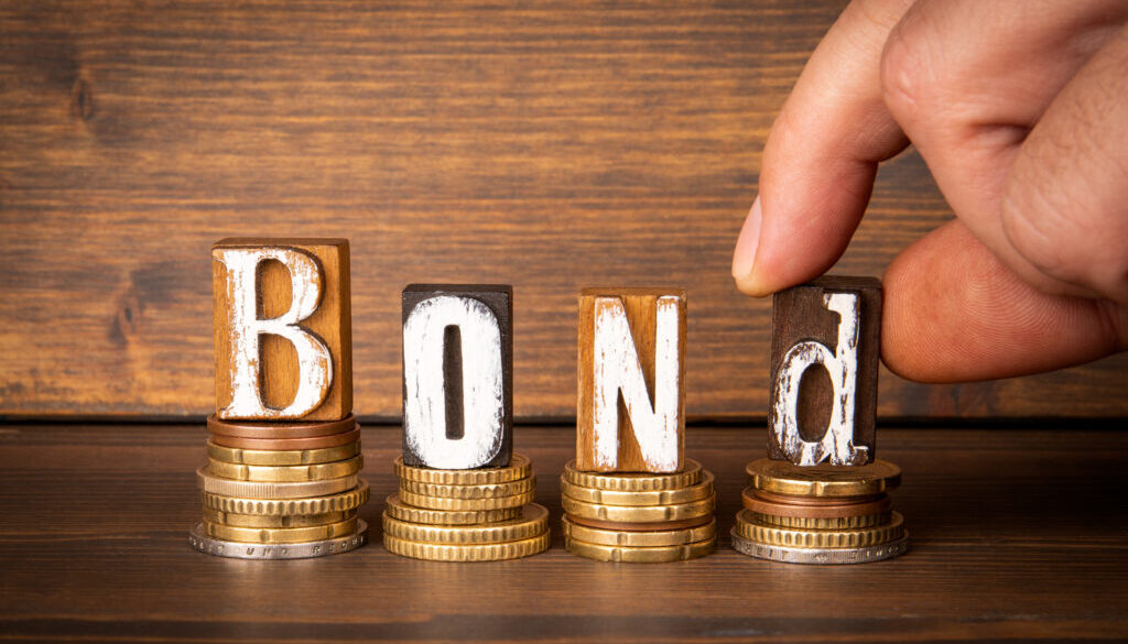 BOND. Money and letters of the alphabet on a dark wooden background
