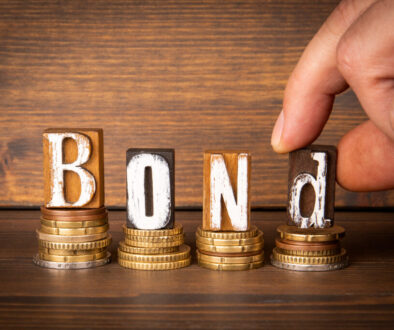 BOND. Money and letters of the alphabet on a dark wooden background BOND. Money and letters of the alphabet on a dark wooden background